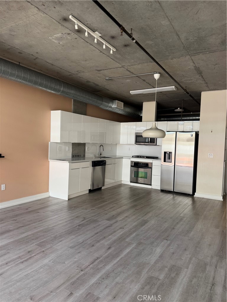 Beautifully home at the Market Lofts. Built in 2006, this modern loft boasts light wood floors and exposed concrete high ceilings. Open floor plan with views of the interior courtyard,. Contemporary counter tops with white cabinetry in kitchen and bathroom. Washer/dryer located inside the unit. Spacious walk-in closet. Relax on your balcony to enjoy your private oasis. The Walk Score is 95! One parking space included. Modern community features include 24-hour security, fitness center, BBQ area, swimming pool, community room with a full kitchen, private screening room with wine fridge and kitchenette. Live in close proximity to Wholefoods, LA Live, Staples Center, Metro station, Macy's, FDIM, USC, Ralph's, shopping, restaurants, entertainment, art galleries, museums, and much more. This is LA urban life at its best! Rent is Include everything except electricity and Wi-Fi.