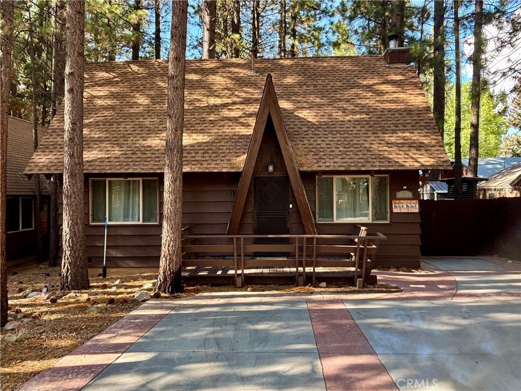 Welcome to your mountain getaway in the heart of Big Bear! This beautifully maintained cabin is perfectly situated in the desirable Lower Moonridge area, just minutes from Bear Mountain Ski Resort, the zoo, golf course, hiking trails, and the lake. Offering the charm of a classic mountain retreat with the comfort of modern updates, this home is currently used as a rental—making it an excellent opportunity for both personal use and investment. Step inside to find a warm and inviting living space with a cozy fireplace, vaulted ceilings, and large windows that bring in natural light and forest views. The kitchen is well-equipped for entertaining, and the open floor plan flows seamlessly into the dining and living areas. Outside, enjoy the spacious deck and peaceful setting surrounded by tall pines—perfect for morning coffee, stargazing, or après-ski relaxation. The location can’t be beat: tucked away for privacy yet close to all of Big Bear’s year-round attractions. Whether you’re looking for a turn-key rental, a family vacation spot, or a full-time mountain escape, this Lower Moonridge gem checks every box.