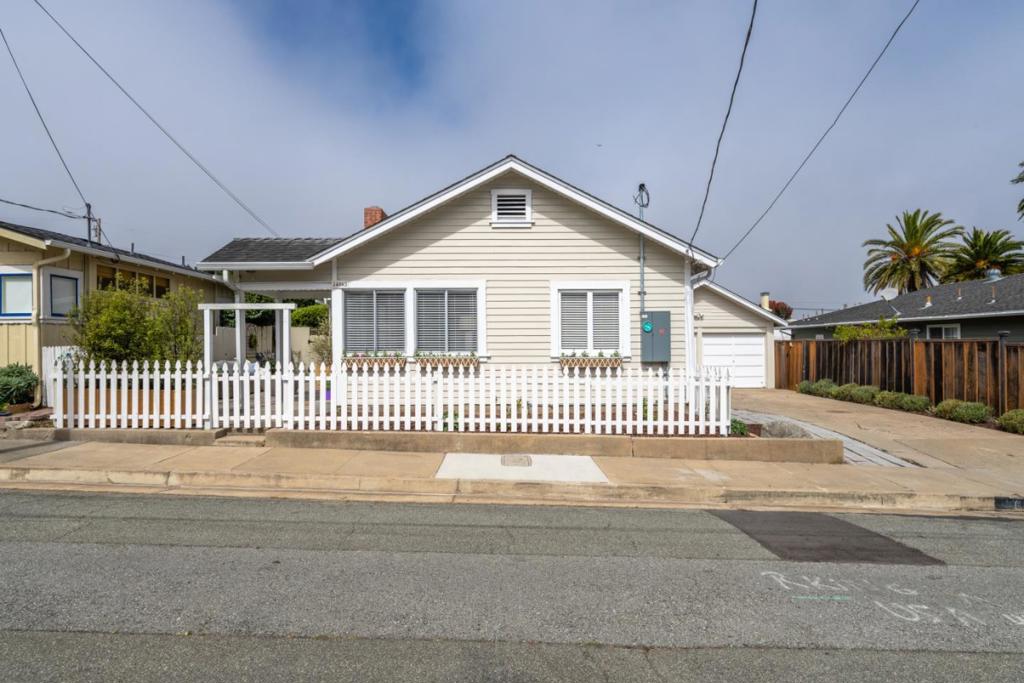 Dreamy beach house in prime location - just a few blocks to the stunning pacific grove coastline, easy walk to beach and town. Behind the white picket fence is a special seaside cottage that has been updated throughout, with 2 bedrooms and 2 bathrooms this single level floor plan lives spaciously and is filled with beautiful natural light. Wide plank floors throughout compliment the overall style. Living room offers different conversation areas and a great fireplace. Dining room is spacious with an old French door that you can open up to take in the ocean breeze, step out to the large front patio and sit by the fire-pit or dine alfresco. Remodeled kitchen with all new stainless steel appliances, quartz counters, ceramic tile backslash and the latest look in light blue painted cabinets is magazine worthy. Kitchen door opens out to backyard and patio. Two hall bedrooms. Both bathrooms nicely redone. Backyard with gorgeous Hydrangeas, redone stone patio, lovely landscape and privacy bushes make this space yet another generous outdoor living area. Patio is sheltered by the garage which has windows and a side door - cosmetically appears like it could to be a cottage or guest house but is actually a nice two car garage. Generous inside laundry room offers various uses. EV car charger.