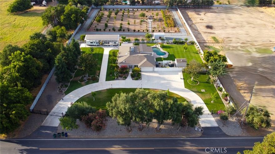Welcome to Your Private Oasis Near UC Merced! Nestled on over 2.6 beautifully landscaped acres, this exceptional fully remodeled estate offers unmatched privacy, luxury, and versatility in a serene natural setting — all just minutes from UC Merced. Step inside this stunning 4-bedroom, 2-bathroom home and discover: a home office with custom built-in desk and shelving, spacious living room plus a formal dining area (or second living space), eat-in kitchen with ample natural light, new composite wood flooring throughout, built in loft in one of the bedrooms, custom window shutters, and newer interior and exterior paint for a modern, turnkey finish. The outdoor features are just as impressive: fully PAID 14.4 kW ground-mounted solar system with two backup batteries, sparkling in-ground pool and built in spillover spa — perfect for summer relaxation, 2 private electric gated entrances with circular concrete driveway, RV hookup with parking pad, new Bosch 5-ton heat pump, energy recovery ventilator, and 50-gallon electric water heater with recirculating pump, efficient irrigation system and lush landscaping, perimeter chain-link fencing and cross-fencing for privacy and pets, gazebo/dog shelter, 2,500-gallon poly water tank with booster pump, abundant fruit trees, roses, and flowering bushes, This property is not only ideal for tranquil living but also offers exciting potential: Build your dream ADU, or explore subdividing the rear portion for future development (buyer to verify with Merced County Planning). Conveniently located just minutes from UC Merced, Merced College, Mercy Hospital, shopping centers, and gas stations — this home delivers the perfect blend of comfort, convenience, and long-term value. Schedule your private showing today and experience the possibilities!
