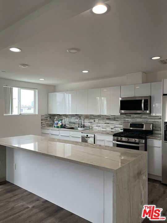 Modern Elegance Meets Prime Location! Welcome to this stunning 3-story single family home boasting 2,207 sq ft of refined living space, ideally situated at the crossroads of Culver City, Santa Monica, Century City, and Beverly Hills. Only five years young, this property offers rare privacy with no shared walls or ceilings, and features a side-by-side 2-car garage plus an additional parking space. A true city luxury. Inside, you'll find sleek laminate and tile flooring throughout, with direct garage access for convenience. The heart of the home is the custom-designed kitchen, featuring quartz countertops, a stylish tiled backsplash, abundant cabinet space, and a spacious center island perfect for cooking, dining, or entertaining. Outfitted with premium LG and Bosch appliances, this kitchen is as functional as it is beautiful. Enjoy the added bonus of a private balcony, perfect for your morning coffee or evening wind-down. The home also includes an eco-friendly tankless water heater, in-unit washer and dryer, and breathtaking city views from inside the home that elevate everyday living. With easy access to the 10 and 405 freeways, this home offers a perfect blend of style, comfort, and location. A Must-See Gem! Don't miss the opportunity to own this private urban retreat. Schedule your tour! Currently, tenant occupied.