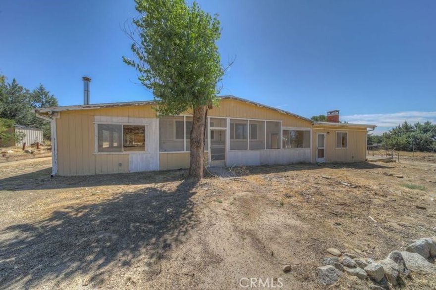 This Property has so much to offer. 2+ acres of ALL FLAT and Usable Land. Divided into sections (Fencing) so you could put sheep in one, chickens/ducks, etc in one, goats, etc. Room for your horses, arenas, stalls, etc and STILL more room.  Because of our mild climates the ability to grow

gardens, and varieties of nut & fruit trees is endless.   

The home is a double wide Manufactured home with 3 bedrooms and two bathrooms and a large additional room approx 500+ s.f. (It could be used as a game room or family room or with some creativity a larger new kitchen.   WE HAVE A LENDER FOR THIS ONE!!!!!

Also attached to the home is an enclosed breezeway and an enclosed dining/game/family type room making your living space another 400+s.f and  options that are endless.

And to top it off a Large 2 car garage and RV garage and Tractor/equipment garage. 

The home is on a paved road and directly down the street from all of the Hamilton Schools. (K-12th)  

Just around the corner from the center of Anza you could even walk to town.  You won't want to miss this opportunity to get creative & make it your own.

Ask about our buyers credit to use for painting or flooring or????