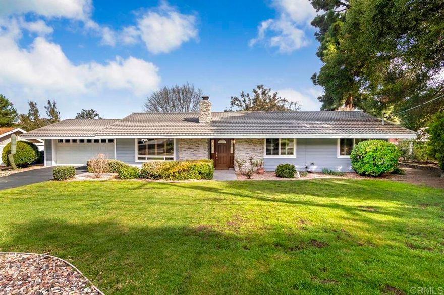 This charming single-story home is sure to win you over from the moment you arrive. Nestled right against the Castle Creek Golf Course, you'll enjoy sweeping views of lush fairways and serene greenery—right from your own backyard. Step inside to a spacious living room featuring vaulted ceilings and a cozy wood-burning fireplace with elegant stacked stone veneer, creating a warm and inviting atmosphere. The classic kitchen offers double ovens, rich cabinetry, a breakfast bar that seats four, and—yes—more stunning golf course views. Open to the kitchen, the dining area flows seamlessly outdoors through a large sliding door, leading to a generous backyard with mature trees, built-in planters, and plenty of space to design your dream outdoor retreat. Whether it’s a pool, garden beds, or an outdoor kitchen, this yard can accommodate it all. The expansive covered patio with Alumawood cover is ideal for year-round entertaining. The oversized primary suite features an ensuite bath complete with dual sinks, a vanity area, and a large shower stall. With easy and convenient access to Hwy 15, commuting or exploring the county couldn’t be easier. This home truly offers the best of both worlds—peaceful golf course living with great connectivity.