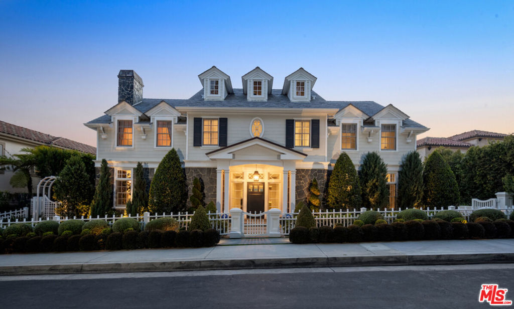 Nestled in the coveted, rapidly appreciating community of Bel Air Crest, this completely reimagined East Coast Traditional blends timeless elegance with modern sophistication. Behind guarded gates with 24/7 security, tennis courts, a clubhouse, and a true neighborhood feel, this estate offers an unmatched lifestyle in one of LA's most desirable enclaves. A grand two-story entry welcomes you into light-filled interiors featuring beautifully refinished hardwood floors, formal living and dining rooms with fireplaces, a handsome library, family room, and seamless indoor-outdoor flow through pocket doors. The gourmet kitchen is outfitted with a Sub-Zero refrigerator, La Cornue range, custom cabinetry, pantry, and a sunlit eat-in breakfast area. A smart-home system adds modern convenience throughout. Entertainment abounds with a theater, 2,000-bottle wine cellar, and children's playroom with a stage. The four-car garage with extensive built-ins plus gated motor court parking for 11 ensures ample space for family and guests. Upstairs, the primary suite features a fireplace, private sitting room, dual walk-in closets, and spa-like bath. Three additional ensuite bedrooms, upstairs laundry, and a finished attic gym with mirrored walls complete the upper level. A guest/maid's suite with private bath is located on the bottom floor, offering privacy and convenience. The backyard is a private oasis with grassy turf lawn, pool, separate spa, fire pit, and built-in barbecue bar, creating the perfect setting for entertaining.