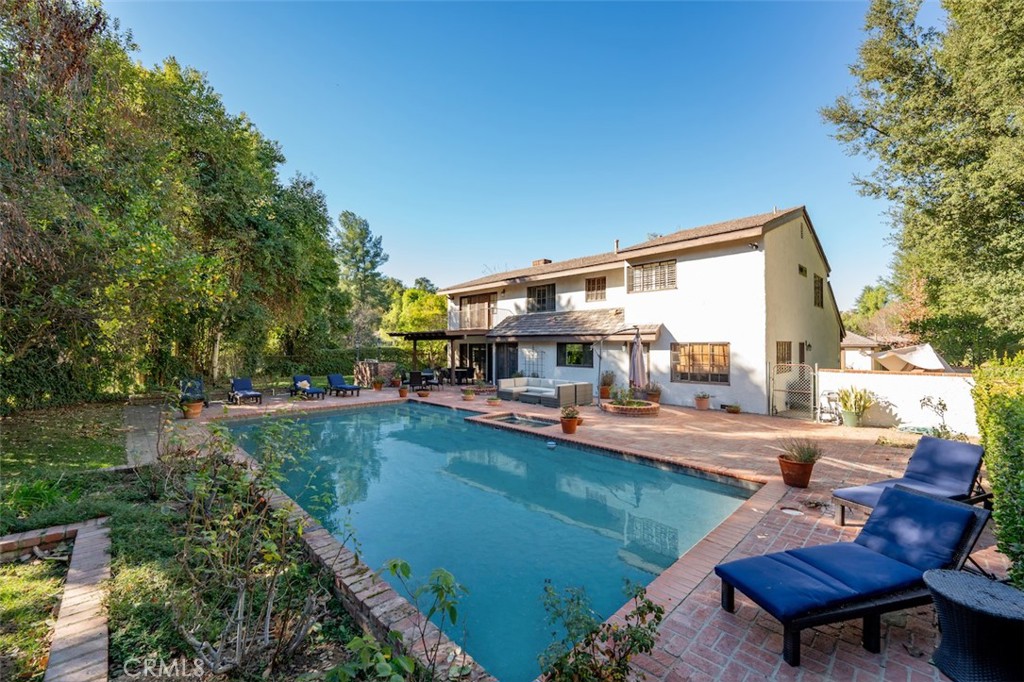 A Hidden Gem in Hidden Hills
Nestled in the prestigious enclave of Hidden Hills, this charming 3800 square-foot estate offers a perfect blend of luxury and tranquility. Set on two flat sprawling acres, the property boasts a wealth of amenities, including a private tennis court, equestrian stables, and a detached guesthouse. The main residence features five spacious bedrooms and five elegantly appointed bathrooms, thoughtfully designed to provide comfort and sophistication.
The open-concept living areas are bathed in natural light, with large windows framing serene views of the lush grounds. A gourmet kitchen with top-of-the-line appliances flows seamlessly into a cozy family room, ideal for entertaining. The primary suite is a true retreat, complete with a spa-like bathroom and walk-in closet. Outdoors, the estate is a haven for recreation and relaxation. The tennis court invites friendly matches, while the stables cater to equestrian enthusiasts. The guesthouse offers private accommodations for visitors or potential use as a home office or studio. With its expansive lawns, mature landscaping, and coveted location, this Hidden Hills gem is a rare find.