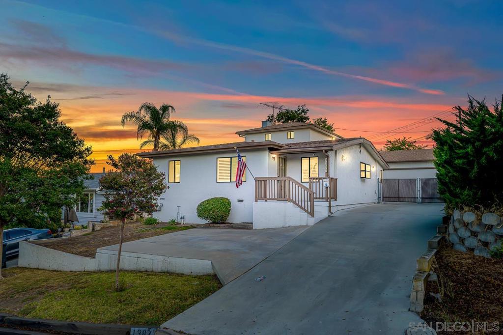 Perched upon a nicely-sized lot in Fletcher Hills, this three-bedroom, two-bath home has recently been updated with tasteful earthen tones throughout. Formal living room with attached separate dining area greet you as you enter. Flowing into the chef's kitchen, which has a quartz eat-at counter, gas stove top and oven, oversized kitchen sink, tasteful backsplash, and plenty of cabinet space. Adjacent is a cozy family room with brick fireplace. Two bedrooms, one bath, and dedicated laundry room complete the first floor. The second floor is home to the primary bedroom with balcony and bathroom. Backyard has a two-car detached garage, deck, and manageable grass area. Plenty of parking with potential RV space.