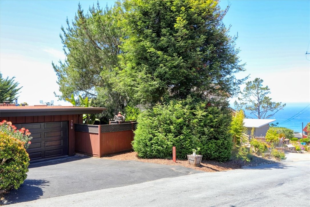 You are going to want to make an appointment to see this house, because the pictures don’t do justice to how cool this house is! This three bedroom, three bath, 1,664 SF house offers SINGLE LEVEL LIVING. Walk straight into the home from the garage and enjoy the two bedrooms, two bathrooms, and the living room, dining room and kitchen all on the same level. Down below is a separate studio apartment with a three-quarter bath. The 6,000 SF lot offers LOTS of entertainment areas outside, with a covered front atrium large enough to host a dozen people. The huge redwood deck, which was recently completely replaced for the tune of $90,000, has numerous areas to sit and enjoy, and also boasts great ocean views! One of MY favorite parts of the house is the rooftop deck! The seller enjoyed countless hours of fun with her friends up on this deck, listening to music and watching sunsets together!