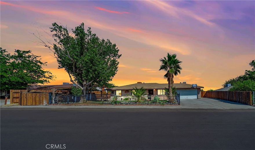 Pride of ownership is apparent as this lovely single story home is being sold by its original owner and offering over 1,100 sq. ft. of comfortable living space!! Inside you'll find 3 spacious bedrooms with the master having its own en suite, 2 full baths, a beautifully updated kitchen with pretty gray cabinetry, granite counters with tile accents, upgraded stainless steel appliances, and a charming dining room area!! Newer dual pane windows throughout with unique ceramic tile floors and wood flooring in one of the bedrooms complemented by gorgeous new fresh interior and exterior paint!! You are sure to love the real brick wood burning fireplace too for those cool winter evenings!! There is also central air/central heating along with a window evaporative cooler to save money in the summer!! The property sits on nearly 30,000 sq. ft. of flat, usable land zoned for horses — tremendous curb appeal with a fully fenced wrought iron privacy fence with gate in the front yard and courtyard area along with fully fenced chain link and cross-fencing in the backyard!! The front yard boasts mature landscaping, grassy areas, and palms, while the backyard features a covered patio, storage sheds, and plenty of space for horses!! An above-ground pool with pump and filter provides the perfect spot to relax, while the 2-car garage with laundry area adds everyday convenience!! This home truly offers it all — comfort, charm, and endless possibilities on a rare oversized lot!! Hurry to go see this special home today before it is sold!!
