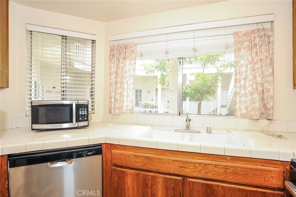 Welcome to your next chapter in this charming two-bedroom, one-bath condo tucked into the heart of Simi Valley. This thoughtfully designed condo offers a blend of comfort and convenience, ideal for those seeking easy living with the perks of a central location.
Step inside to find a bright, functional layout with ample natural light and cozy living spaces. The real star of the show is the large outdoor patio—perfect for morning coffee, evening BBQs, or pretending you’re a plant parent of the year.
For weekend adventurers or those with an errand checklist, you’ll love being within walking distance to Grocery Outlet, just over 500 feet away. Need to commute or explore? A short trip takes you to the train station on East Los Angeles Avenue. If retail therapy calls, the nearby Town Center Mall has you covered. Appreciate the proximity to Santa Susana High School, while Darrah Volunteer Park offers a green escape for picnics or frisbee "training."
Outside your front door, a well-maintained jacuzzi adds a relaxing touch. With everything you need just around the corner, this condo is more than a place to live—it’s a lifestyle choice.
Enjoy the balance of suburban tranquility with city amenities all within reach. Schedule your showing today—because relaxing on your own patio beats circling for parking on a Saturday.
All items are no gurantees or promises. HOA items and incluses are responsibility of potential buyers to confirm. Photos on listing contain digital staging as property is not actually staged for sale.