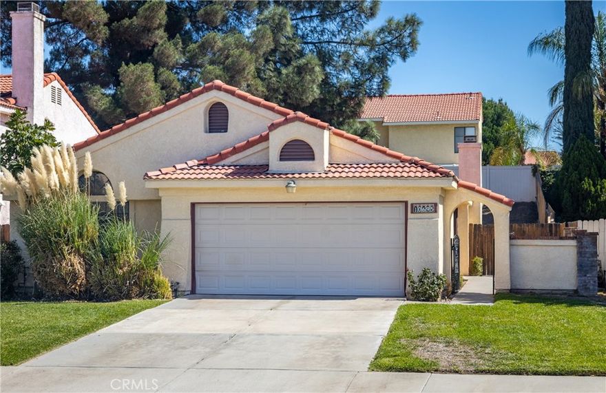 Charming Single-Level Home!!  Welcome to this adorable single-level home ideally located between Crafton Elementary and Redlands East Valley High School. A gated entry offers added privacy and the perfect opportunity to create a welcoming courtyard. Step inside through the security door to a spacious living room featuring a cozy fireplace and sliding doors that open to a covered Alumawood patio—ideal for outdoor relaxation or entertaining in your private backyard. The versatile floorplan includes a third bedroom or office option with double-door entry to the living area. The kitchen and dining space overlook the rear yard and feature a brand-new stainless steel stove and microwave, plus the added bonus of a stainless steel refrigerator.The large primary suite enjoys peaceful views of the backyard and includes a generous walk-in closet. The primary bath offers a dual-sink vanity, a shower over a large oval soaking tub, and a private commode area. Additional features include an indoor laundry room with washer and dryer, a hall bath with shower over tub, and a front-facing third bedroom.The finished two-car garage provides direct access to the home and is upgraded with epoxy flooring, a roll-up door, and an automatic opener. Freshly painted, newly carpeted, and professionally cleaned—this move-in ready home is waiting for you!
