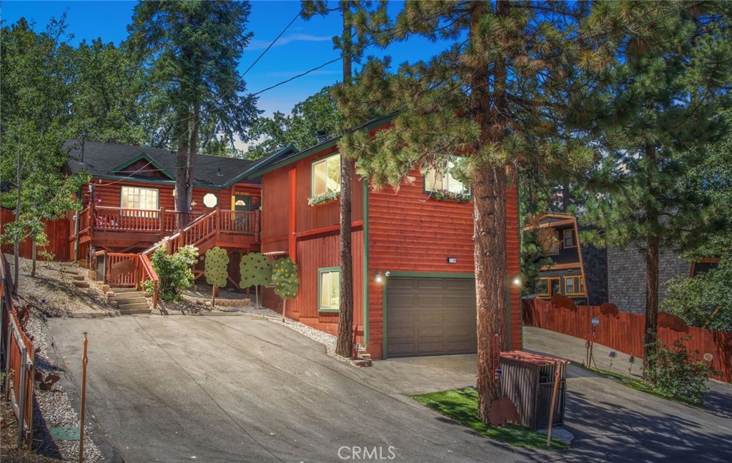 Beautifully Upgraded Moonridge Retreat! Set on a private, well treed lot with lake and mountain views, this meticulously maintained property blends relaxation and style. The main home offers a convenient ranch style layout with wood lined vaulted ceilings in the main room, 2 bedrooms and 2 baths, including a spacious master suite. Notable upgrades include new flooring throughout, mini splits for added comfort, an open remodeled kitchen that features granite countertops, freshly painted cabinets and stainless steel appliances. Bathrooms are beautifully updated with marble counters and modernized vanities. A rare find, the newly added detached guest suite adds a third bedroom, third bath, and 480 sq ft of additional living space, along with an oversized garage below that includes an EV charger. Outdoors, enjoy extensive landscaping, a putting green, and multiple decks for entertaining or relaxing. Also includes an oversized shed with ample room for storage. Don't miss this one...pride of ownership is evident in every detail!