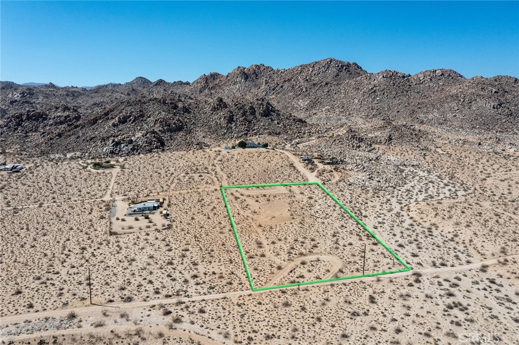 5+ Big Acres located in Prestigious Panorama Heights. Close to National Park and BLM-government-owned property. Boulder mountains nearby. Approved plans by SB County. Water and electricity nearby. Ready to develop. Rural feel and location, yet convienent to downtown Joshua Tree for dining and shopping. Great parcel for individual or general contractor seeking large, rural parcel to develop. NOTE: Green lines demarcating boundaries in pictures are approximate. APN: 0604-061-09