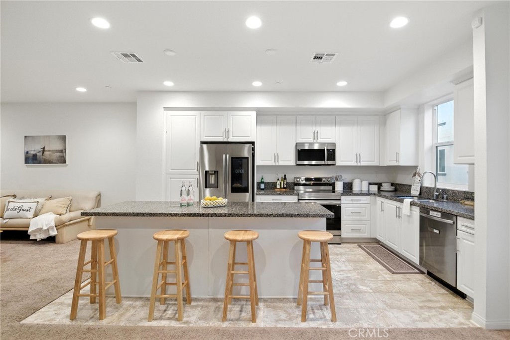 Discover this stunning modern tri-level townhome, built in 2023, featuring an impressive design and abundant natural light throughout. With no Mello Roos, solar panels this home has an open-concept main level with soaring 9-foot ceilings, a spacious living area, and a contemporary kitchen equipped with stainless steel appliances and a large center island, ideal for entertaining. This exquisite residence includes four bedrooms, with the master suite featuring an ensuite bathroom and a generous walk-in closet. The other three spacious bedrooms share well-appointed bathrooms, perfect for a family, guests, in-laws, or a home office setup. Additional highlights of this home include an indoor laundry with a full-size stackable washer and dryer, an attached two-car garage equipped with EV charging, and a private balcony patio that overlooks the freeway and lush, park-like common areas. The community amenities provide BBQs, picnic spots, and garden beds for residents to enjoy. Located near the border of La Mesa and Lemon Grove, this property is just minutes from the vibrant shopping and dining options in downtown La Mesa and a short drive to downtown San Diego. This beautifully designed townhome is absolutely stunning and completely move-in ready!