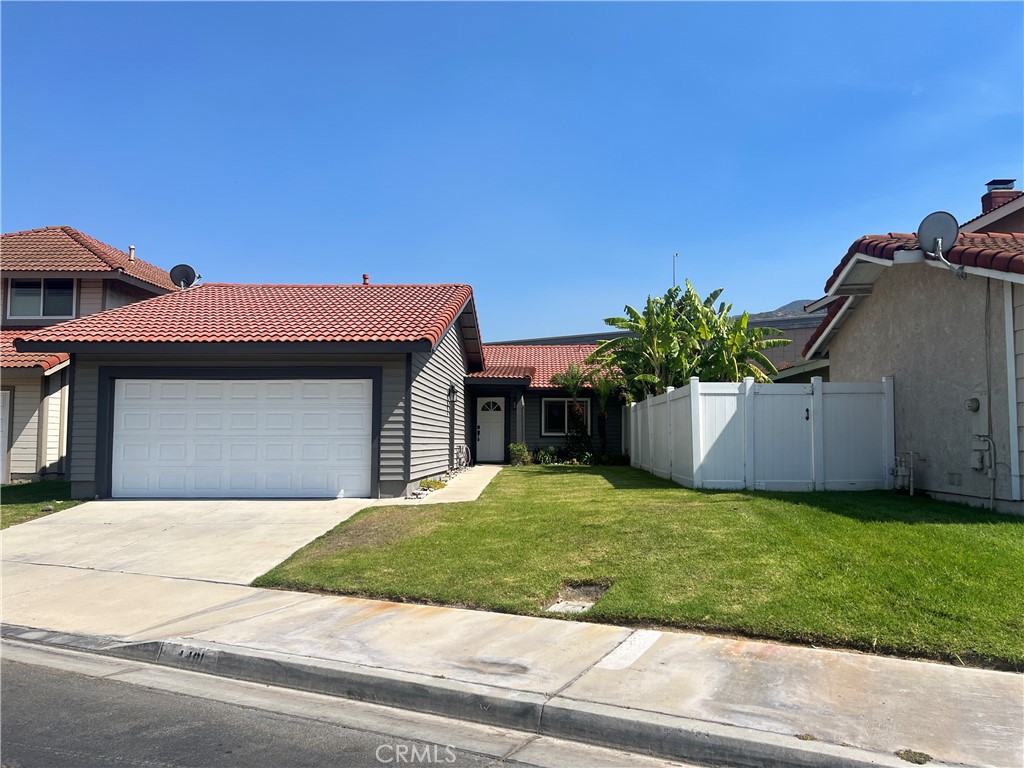 LOCATION! LOCATION! LOCATION! Rare opportunity to lease an updated single-story home in the desirable Green River community, near the 91 & Green River Rd, close to the OC/Riverside border—ideal for commuters! This home has been updated throughout and features 3 spacious bedrooms, 2 remodeled baths with quartz countertops, laminate flooring throughout, and an open floor plan with a stone fireplace. You'll love the fully remodeled kitchen, showcasing white custom cabinets, stainless steel appliances, and a large sink overlooking the backyard. The primary suite includes high ceilings, a sleek light fixture, an ample-sized closet, and slider access to the side yard. The primary bathroom offers dual sinks, quartz counters, and a large walk-in shower. Two additional bedrooms sit on the opposite side of the home, separated by a hall bath featuring a jetted tub/shower combo and a quartz countertop vanity. Step outside to a fully landscaped backyard with stamped concrete, a covered patio, mature fruit trees, planters, and mountain views—a perfect space to relax or entertain. Additional features include multiple sliding doors for seamless indoor-outdoor flow, an attached 2-car garage with washer/dryer hook-ups (accessible from the front of the home), and extra driveway parking. The Green River community offers resort-style amenities, including a clubhouse with kitchen, large pool and spa, tennis and pickleball courts, basketball court, dog park, scenic hiking trails, and a BBQ area—perfect for both relaxation and recreation. This gem won’t stay on the market long—schedule your tour today!