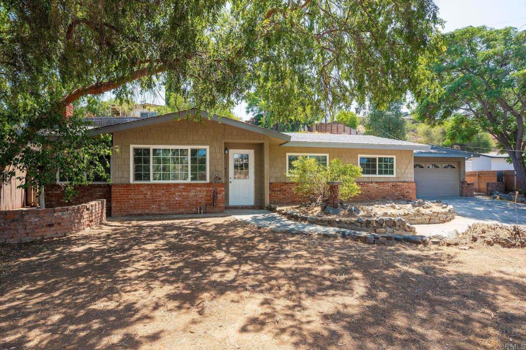 Welcome to this well-maintained 3-bedroom, 2-bath Ranch-style home, ideally situated on an elevated lot that offers added privacy and scenic sunset views. Step inside to a spacious open-concept living area complete with a cozy fireplace - perfect for gathering with family and friends. The large kitchen and dining area combo provides ample space for entertaining and everyday living. Outside, the newly repaved driveway leads to an automatic gated entry, enhancing both convenience and security. Relax in the elevated front yard or explore the potential of the flat, lower portion of the lot—ideal for RV or boat parking, a storage shed, or additional outdoor uses (buyer to verify with county regarding zoning and permitted use). Refrigerator, washer, and dryer are included—just move in and make it yours!