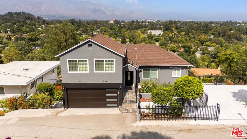 Nestled in Pasadena's desirable San Rafael Hills, this serene home offers unobstructed panoramic views of rolling mountains, cityscapes, and distant snow-capped peaks. The main house features 4 spacious bedrooms and 4 bathrooms, including two luxurious master suites. Enjoy indoor-outdoor living with folding glass doors that open to large balconies, perfect for relaxing or entertaining. The chef-style kitchen is a dream, with quartz countertops, stainless steel appliances, an oversized center island, and plenty of natural light. Bedrooms include walk-in closets and spa-like bathrooms for ultimate comfort. A fully permitted ADU with its own address: 332 Anita Drive, adds even more space and flexibility. It features its own private entryway, 2 bedrooms, 1 bathroom, a full kitchen, laundry hookups, a private deck, and a new water heater. The ADU provides a versatile option to generate income or qualify for an income tax write-off by using it as a home office. It's ideal for guests, extended family, or rental income. Additional features include all-new plumbing and electrical systems, an attached two-car garage, two covered carports, and a large separate storage areas. The expansive backyard is perfect for summer gatherings, featuring mature fruit trees, lush landscaping, a putting green, and a spacious flat grassy area. All of this is just minutes from the Rose Bowl Stadium, Norton Simon Museum, Annandale Golf and Tennis Club, The Huntington Library, and the world-famous Rose Bowl. Schedule your private tour today and experience Southern California living at its finest.