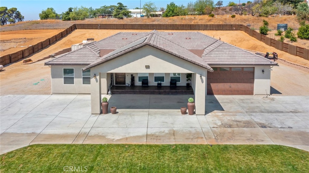 Imagine having paid off solar panels, your own water well, your own propane tank! Rarely does an opportunity arise to own a custom-built home in sought-after Cherry Valley. Nestled on a fully fenced property, this estate welcomes you through dual gated entrances and a covered driveway leading to a stunning 8-foot entryway.
Step through the 8x4-foot alder wood door into an open floor plan that seamlessly blends elegance and functionality, with high ceilings adding warmth and charm.
The great room, featuring a cozy fireplace, flows into the gourmet kitchen, complete with maple cabinetry, marble countertops, and a waterfall-style island-perfect for entertaining. Each spacious bedroom boasts a private en-suite bathroom with a shower, ensuring ultimate comfort and privacy. A dedicated office (or potential 4th bedroom), guest bath, and laundry room complete the interior.
The primary suite is a luxurious retreat with an upgraded travertine bathroom, while the oversized garage impresses with 14-foot ceilings and a 10-foot garage door, ideal for larger vehicles or storage needs.
This property is equipped for sustainability and self-sufficiency, featuring: Hannon Water Rights with a large agricultural water allocation, 500-ft Well producing 90 gallons per minute, 5,000-gallon Water Tank & private fire hydrant, Solar Panels & Propane Tank that are paid off, 9-ton AC unit, Tankless Water Heater, Generator port for backup power, 50-amp RV connection including a dumping area.
A true gem in Cherry Valley, this home offers a perfect blend of modern luxury, efficiency, and agricultural potential. Don't miss out on this exceptional opportunity-schedule a showing today!