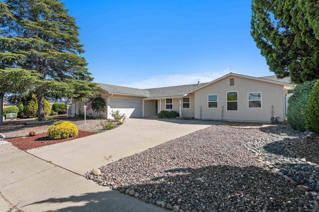 Welcome to this thoughtfully maintained home nestled in the desirable Seven Oaks community, where comfort and convenience come together in a truly inviting setting. This charming residence offers four spacious bedrooms and two well-designed bathrooms, making it ideal for everyday living. Abundant natural light fills the home, enhanced by ceiling fans in every room to keep things comfortable year-round. The generous primary suite offers a peaceful retreat, featuring a spa-inspired bathroom with a dual-sided fireplace for added warmth and ambiance. A large walk-in closet provides ample storage, and a separate indoor laundry room adds extra functionality. The expansive backyard is perfect for entertaining or relaxing, complete with a covered patio and a sunroom equipped with air conditioning for year-round enjoyment. The finished garage features a durable epoxy floor, combining practicality with a clean, polished look. Outside, the low-maintenance landscaping and spacious backyard are framed by sweeping mountain views, offering a tranquil outdoor escape. As a resident of Seven Oaks, you'll enjoy access to a vibrant 55+ community with clubs, activities, a pool, spa facilities, and pickleball courts—all just minutes from shopping, dining, and easy access to Highway 15. This home offers a perfect blend of thoughtful design, comfort, and a welcoming community—an exceptional place to call home.