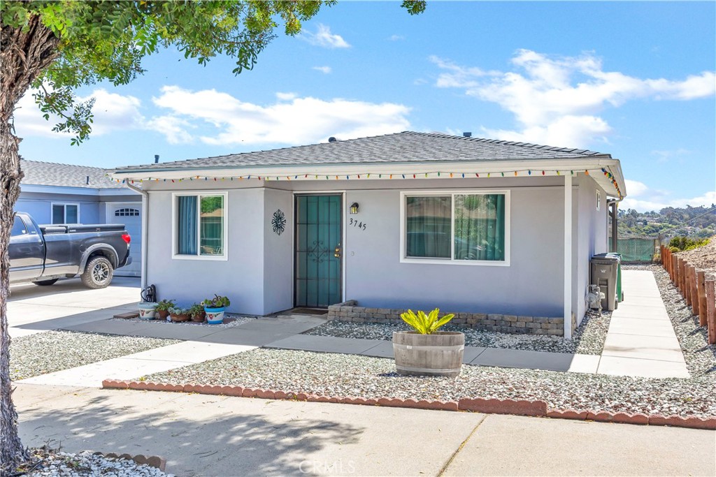 Charming and updated single-family residence located in the heart of Oceanside, CA 92056. This delightful home features 2 cozy bedrooms, 1 modern bathroom, an open-concept living area, and a stylish, fully equipped kitchen adorned with stainless steel appliances, elegant gray cabinetry, and sleek countertops. The spacious living room seamlessly merges into the dining space, ideal for entertaining. Natural light floods the interiors, creating a warm and inviting atmosphere that complements the soothing color palette and plush carpeting throughout. Each bedroom offers comfort and tranquility, with the master bedroom boasting direct access to the covered outdoor patio. Outside, the extended patio provides a perfect setting for relaxation and enjoys picturesque views of the surrounding landscape—ideal for dining al fresco or enjoying cool evenings. Low-maintenance landscaping and a serene location add to the peaceful charm of this home. ****The home boasts a new roof, new pergola, new windows, new paint, additional concrete, laundry relocated to the garage, and a VIEW!!!! Enjoy proximity to local amenities, schools, and quick access to freeways for a convenient lifestyle. This property is a must-see for anyone seeking a comfortable and stylish home in Oceanside!