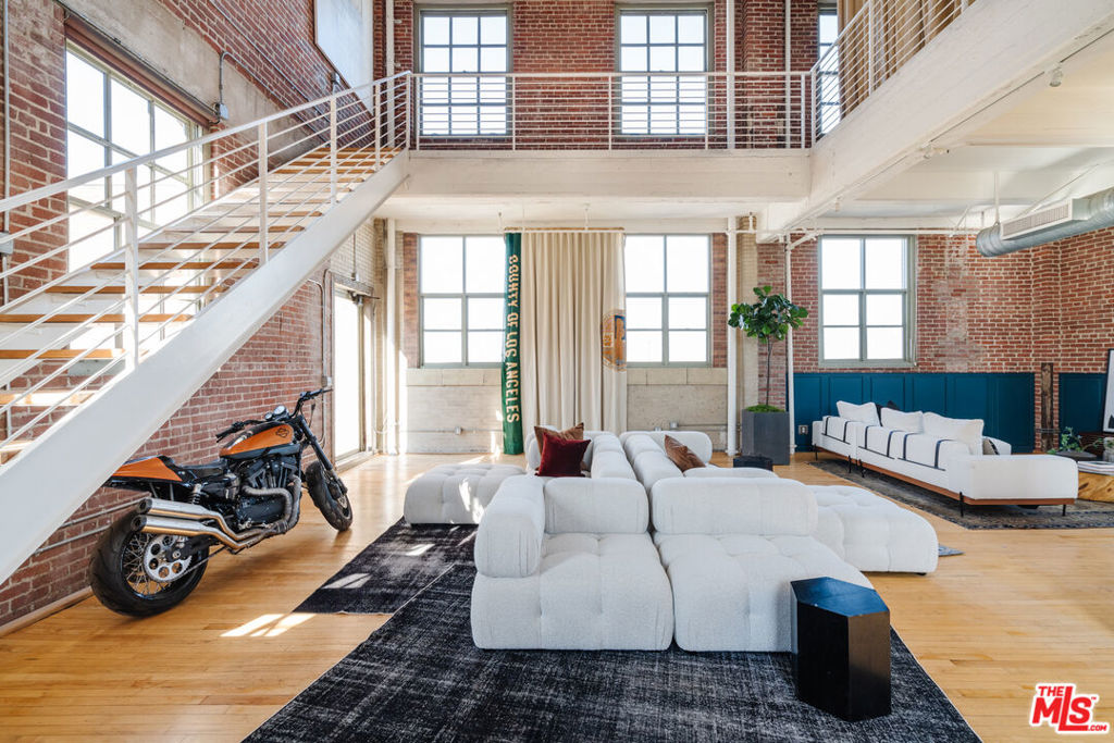 Incredible scale, tremendous volume and 360 degree jetliner views position this rare historic penthouse as the most significant mixed-use offering in Downtown LA's thriving Arts District. Originally constructed in 1925 by E.J. Eckel as the West Coast headquarters of Nabisco, this magnificent structure was converted to a live/work community in 2007, the same year it was declared a Historic Cultural Monument. Spanning four levels atop the 7th floor, this grand scaled unit provides the ultimate canvas to create, produce, live, entertain and play all in one. Recently outfitted as the headquarters of a major film production company, this museum-like dwelling occupies 4,300 square feet of interiors with original maple hardwood floors and a remarkable 3,600 square feet of private outdoor terrace space. A flexible canvas enjoys a variety of floor plan layouts depending on your style, with the main living spaces and kitchen on the second floor, and a voluminous owner's suite occupying the entire third floor. Start and end your days with incredible sunrise and sunset views from a towering rooftop deck, providing exceptional scenery from LA's mountain ranges, through Downtown, and over to the coast, revealing an incomparable wow perspective of the Los Angeles basin. Ideally located with easy access to the Westside, Hollywood and Valley studios while just around the corner from the new Soho Warehouse and the Arts District's bustling eateries and sceneries. Truly one of a kind- extremely private with around the clock concierge, a zen garden terrace & swimming pool, the tax saving Mills Act, and a celebrated piece of genuine Angeleno history, this once in an era setting is the best Downtown LA life has to offer. Home, is here.