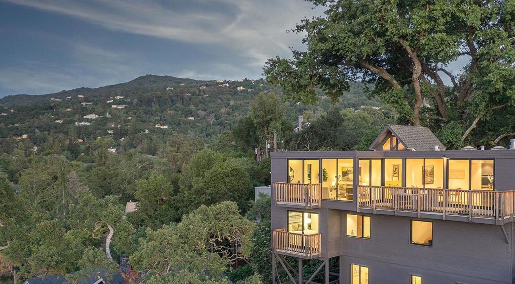 Discover the best of Los Gatos living with this rare offering, two distinct homes on over ¼ acre, showcasing sweeping city lights and mountain views. Just minutes from vibrant downtown, this property blends mid-century modern architecture with minimalist boho design, creating an open, harmonious space drenched in natural light. The 2,200± sf, 3-bedroom, 3.5-bath main residence features clean lines, walls of glass, and seamless indoor-outdoor flow. Thoughtfully remodeled with high-end, eco-conscious finishes, it preserves the integrity of its original style while offering modern comfort. The separate 926± sq ft, 1-bedroom, 1-bath ADU is full of charm with high ceilings, hardwood floors, and oversized picture windows that frame garden and city views. Recent ADU upgrades include a designer kitchen, new bathroom with heated floors, new roof, and updated plumbing and electrical. Private, tranquil, and just a short stroll to downtown shopping, dining, hiking trails, and top-rated Los Gatos schools, this is a rare opportunity to enjoy space, views, and the coveted downtown lifestyle.