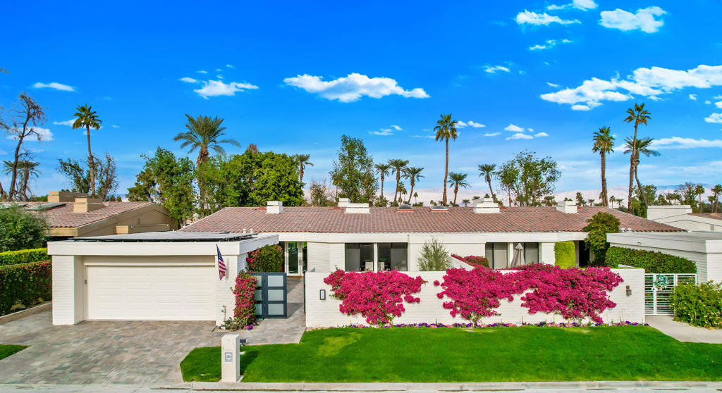 Experience the pinnacle of luxury living in this fully remodeled, contemporary 4-bedroom, 4.5-bathroom masterpiece in the heart of Indian Wells. This stunning property includes a fully paid-off 22-panel solar system, offering unmatched comfort, style, and sustainability. Enter through a private courtyard into an expansive 3,307 sq ft open-concept design, perfect for intimate gatherings and grand entertaining. The home boasts exquisite white porcelain tile, soaring cathedral ceilings, and abundant natural light, creating a sophisticated and inviting ambiance.The primary suite is a sanctuary with an impressive walk-in shower, dual vanities with matching stone finishes, a spacious walk-in closet, and patio access. Each additional bedroom offers en-suite baths, walk-in closets, and ample space. A beautifully appointed powder room completes the interior. The outdoor living space is a true haven, featuring breathtaking fairway views, stunning sunsets, a fire pit, a bar area, and new pavers surrounding the property. Perfect for relaxation or entertaining, the back patio seamlessly blends style and comfort. Eco-conscious amenities include an electric vehicle charging outlet in the 2-car garage, golf cart access, and a solar system for energy efficiency. This fully furnished, turnkey home nestled in one of the desert's most sought-after communities. Don't miss this exceptional opportunity. Schedule your private showing today.