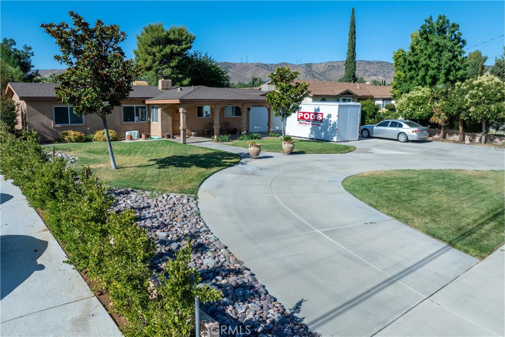 Welcome to this beautifully renovated 3-bedroom, 2-bath home spanning 1,960 square feet on a spacious 1.13-acre lot. Meticulously upgraded in 2013, this residence features an owned 24-panel solar system installed just seven years ago, offering energy efficiency and savings. Step inside to discover stunning architecture complemented by real wood floors and custom blinds throughout. The cook's kitchen is a true delight, boasting granite countertops, a 5-burner cooktop, under-counter lighting, pull-out spice racks, and a huge pantry for all your storage needs. The large living room is centered around a striking feature wall with a cozy fireplace, perfect for gatherings and relaxation. The master suite offers dual sinks, a separate shower, an oversized tub, and a sliding glass door that opens to the back courtyard, providing seamless indoor-outdoor living. Additional highlights include a spacious laundry room with a sink, a beautifully fenced courtyard, and cross-fenced backyard ideal for pets or gardening. The entry door features a peek door, allowing you to see visitors or enjoy a gentle breeze safely. RV access is a bonus as is the additional entry to the property from Ave. M6 and water that is piped all the way to the back of the property. For your convenience, the washer, dryer, and refrigerator will remain with the home. Don't miss the opportunity to own this exceptional property combining comfort, style, and sustainable living. Schedule your visit today!