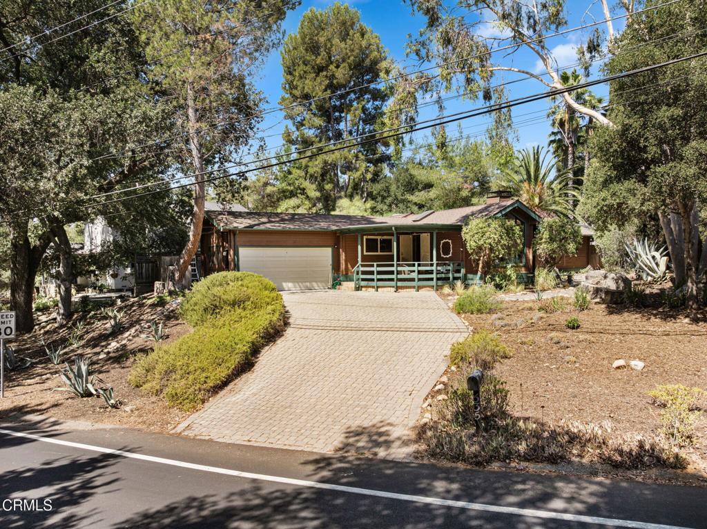 Welcome to this beautifully maintained 3-bedroom, 2-bath home offering nearly 2,000 square feet of living space on a quarter-acre lot in the heart of Ojai. Built with solid cedar wood construction and thoughtfully updated over the years, this home features a spacious living room with a fireplace, a library with custom built-ins, maple wood flooring, a bright dining area, and remodeled bathrooms completed in 2025. A versatile back unit with a wet bar and separate entrance provides endless possibilities such as a studio, office, or rental opportunity.Recent improvements include updated plumbing with a transferable warranty, newer windows, roof, and A/C replacements, along with a whole-house fan. The landscaped yard is highlighted by fruit trees, flowering plants, and mature oaks, creating a peaceful setting for outdoor enjoyment. The two-car garage includes side panels that open for natural light and ventilation, making it suitable for a potential workshop.Located within walking distance to Downtown Ojai, Libbey Park, farmers' markets, restaurants, shops, trails, and cultural venues, this property offers the perfect blend of comfort, convenience, and natural beauty.