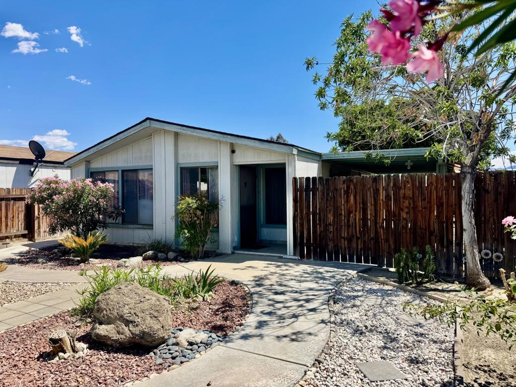 Located in the 55+ Gated Community of Desert Grove community. Low monthly HOA of only $265. Residents enjoy access to a refreshing pool, soothing spa, and a clubhouse complete with a pool table for socializing. RV parking is also available for a low fee. Step inside and be impressed by the open floor plan featuring 2 bedrooms, 2 bathrooms, and spacious living room. The kitchen features a gas cook top and breakfast counter. The living room is warm and inviting. The primary suite is a relaxing retreat with a soaking tub and walk in shower. 2 car garage. Beautifully landscape yard and spacious side patio perfect for outdoor dining. Great central location close to shopping and restaurants.