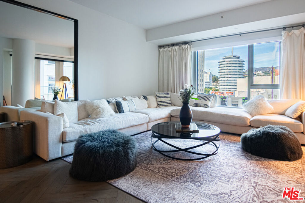 Fully Furnished, stacked and ready for your enjoyment! Located in one of LA's most prestigious A+ buildings. This spacious 1,720 sq. ft. condo features 2 bedrooms and 3 bathrooms. The condo offers luxury services such as 24-hour concierge and valet, and is fully upgraded from its original design. It boasts stunning north-facing views of iconic landmarks including the Pantages Theatre, Capitol Records Building, and the Hollywood Hills. The interior showcases premium finishes, such as a beautiful waterfall countertop and elegant wishbone hardwood floors. The expansive master suite includes a large master bath with dual sinks, a soaking tub, and a separate walk-in shower. A huge, built-out walk-in closet with lockers adds further luxury. The modern chef's kitchen is equipped with top-of-the-line appliances: a SubZero refrigerator, wine cooler, Kuppersbusch stove, and dishwasher.