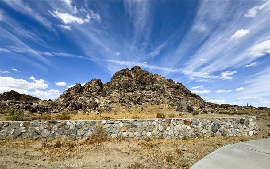Check Out this 3.3-Acre Property with MAIN ROAD Frontage at 30588 CA-18, Lucerne Valley! Located on the WEST Side of Town with Outstanding HIGHWAY Exposure, this Unique Lot Boasts a Rocky Butte/MOUNTAIN to Explore, INCLUDING A SMALL ROCK ROOM Carved into the Rock — Perfect For Storage, Shelter or Just Exploring! A Large Concrete DRIVEWAY is Already IMPROVED on the Site. With ELECTRICITY and NATURAL GAS Likely Easy to Connect (a House Was Previously On-Site — Buyer to Verify), the Utilities Are Very Favorably Positioned. Zoned LV/RL, VIEWS of the Desert & Mountains. This Property is Full of POTENTIAL — Don’t Miss the Chance to See It in Person!