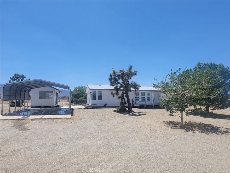 Welcome to this Beautiful Remodeled 3 bedroom 2 bathroom custom manufactured home on a Permanent Foundation located in Phelan on 2.2 acres! Pride of ownership shows with stunningly new custom laminated wood floorings throughout the kitchen and living areas. Brand new carpet in all bedrooms. Brand new dual pane windows and blinds throughout home. Newly painted throughout the entire home inside and out. Some great other features are a Ginormous Family Room - Living Room – Great Room with a New Ceiling Fan - Large Breakfast Nook/Eating area flows into to Upgraded and fully renovated kitchen with white cabinetry, Super Nice White Quartz Counter Tops and Gorgeous new Stainless-Steel Appliances. Home features Master bedroom spacious with a  HUGE private new remodeled standing shower with double shower heads and plenty of natural light and completely upgraded throughout. 2nd bathroom was upgraded as well with Super Nice White Quartz countertops and fixtures. . Nice and Big 2.2 developable acres lot fenced and gated. Easily used as Horse property  Very nice extra Game Room or studio or arts and crafts room also upgraded and painted ready for your needs. HUGE well built covered carport enough to fit multiple cars all concreted.. Bring all of your favorite Recreational Toys, RV’s Boats. Plenty of room for and ADU (Additional Dwelling Unit) and additional Workshop. Country Living at its finest…! Super Close to town, stores, and schools – In the highly desirable Snowline School District – The Highest Rated School District in the High Desert. Home is located a short distance from paved street and Freeways.This home won't last long. Ready to move in…!