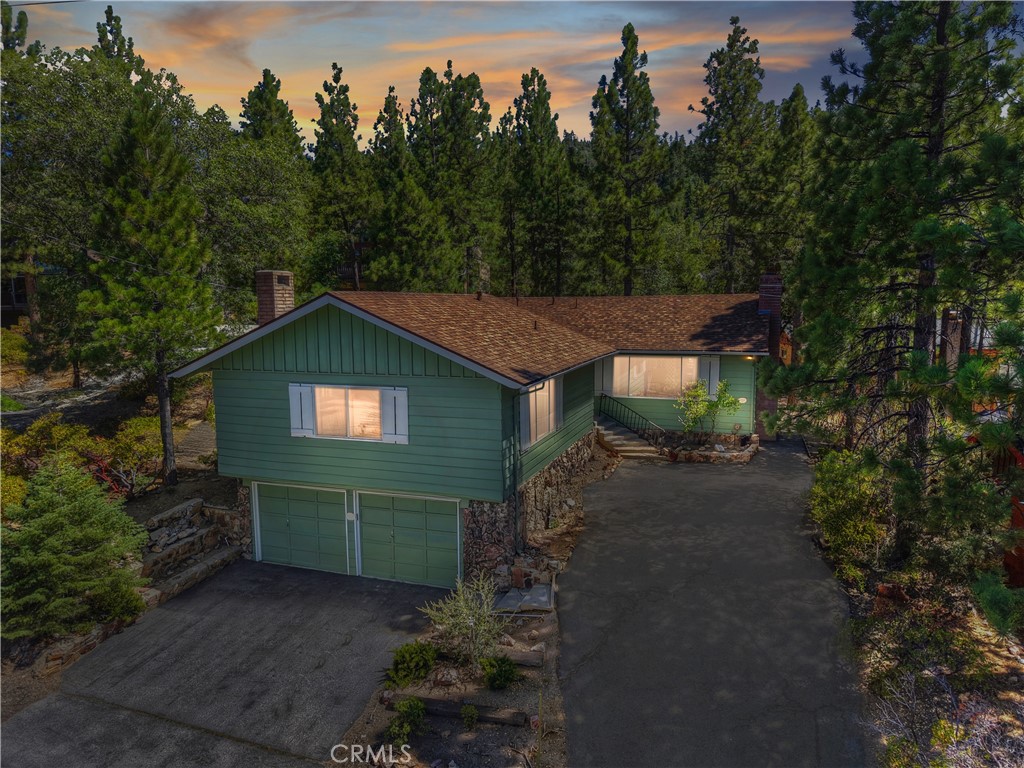 This home has been well loved by the same family since the 60's and now is your chance to make it your own ~ Walking distance to the Village of Big Bear for dining, shopping and night life ~ Walking distance to Pine Knot Marina where you can do watersports, go for a cruise on the Big Bear Queen or a tour of the lake on the Pirate Ship ~ As you enter you will be taken back in time with original decor and finishes giving you a true retro feel ~ There are two bedrooms, two full bathrooms, a large living room with a native rock fireplace with raised hearth and wood burning stove insert and peak-a-boo lake views ~ The massive family room over the 2 car garage features a wet bar and your second native rock and wood burning fireplace and peak-a-boo lake views ~ The kitchen has tons of storage space and overlooks the concrete back patio and into the backyard ~ The brand new roof was installed in July 2025 ~ They have also had a new garage door opener and rain gutters installed ~ Whether you are looking for a mountain home with a retro vibe or a great home to make your own, this is one you will regret missing out on!