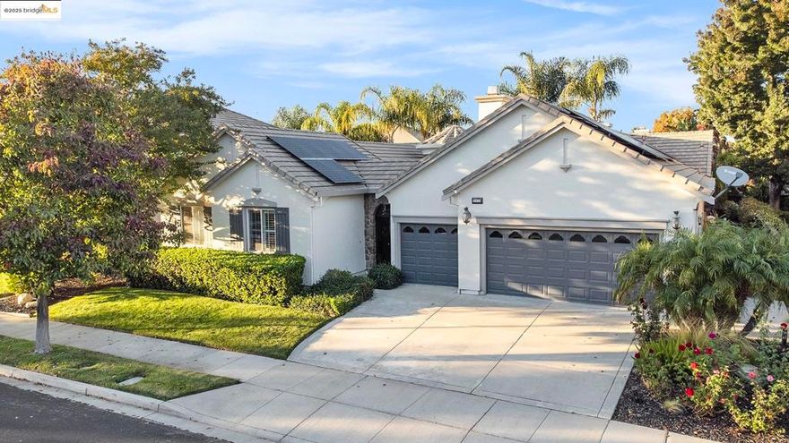 Stunning 4BR + den single-story retreat with gated courtyard & outdoor gas fireplace. Enter through a dramatic turret-style foyer into an open-concept living space with rock-tiled openings, tumbled travertine floors, crown molding, and plantation shutters. The gourmet kitchen impresses with blonde maple cabinetry, granite counters, double ovens, gas cooktop, second prep sink, two kitchen bars, and expansive walk-in pantry—perfect for entertaining. Family room with custom media wall & gas fireplace insert. Luxurious primary suite with spa-inspired marble bath, soaking tub, and oversized walk-in closets. Laundry room with sink plus included washer, dryer & refrigerator. Outdoor paradise features heated pool & spa with waterfall, built-in BBQ & smoker, outdoor fireplace, landscape lighting, and all backyard furniture included. 32 owned solar panels and 10 pool panels offer energy-efficient, low-maintenance luxury.