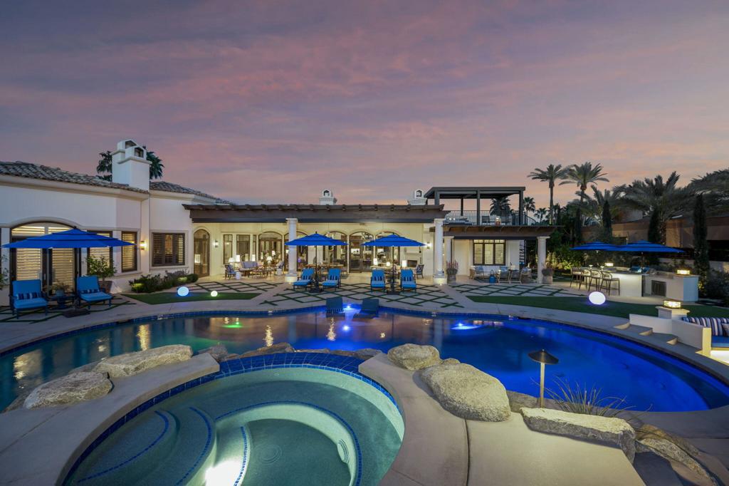 Live each day as if you're on an endless vacation behind the gates of this stunning remodeled estate at Rancho Mirage's guard gated Mission Ranch community on Clancy Lane. The extraordinary custom residence presents a beautiful homesite of nearly 1.04 acres that allow generous room for newly reimagined grounds that rival the area's exclusive five-star resorts. All-new landscaping & hardscaping complements a pool with Baja shelf, spa w/ rock waterfall that flows into the pool below, a luxe cabana, sunken seating area with an open-air fireplace, a tranquil rose garden with fountain, a new outdoor kitchen with BBQ and bar, an extended covered patio with fireplace, and a rooftop deck with new cover and sweeping mountain views. In the backyard, a lighted tennis court is joined by a brand-new guest house w/ bath and kitchenette, custom fountains and new covered patios. Enter through the octagon foyer & marvel at coffered 14' ceilings. This bright and open showplace promises comfort for all w/ 6 beds, 7 bath, a great room with walk-in wet bar, and a family room with a fireplace that is shared with the living room. A brand-new kitchen shines w/ quartz countertops, new custom cabinetry, 2 islands, a walk-in pantry, 2 dishwashers, a double built-in refrigerator flanked by 2 full-size wine refrigerators, and a pro-level Wolf range. Relax in a wood-paneled octagon library library with fireplace, and entertain stylishly in a formal dining room with bay window. A true masterpiece!