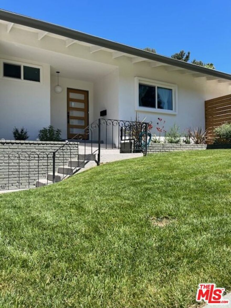 Welcome to your dream home south of Ventura Boulevard in Woodland Hills! This excellent 3-bedroom, 2-bathroom property has been masterfully reimagined, providing contemporary luxuries in a highly-desirable pocket complete with a sparkling pool and finished garage. As you step through the front door, you'll be greeted by an inviting and spacious living area adorned with new gleaming floors and a stone fireplace. The floor plan seamlessly moves from the living room to the dining area and kitchen, making it an ideal space for both relaxation and entertaining. The kitchen is a chef's delight, boasting beautiful stainless-steel appliances and new countertops which provide ample space for meal preparation and a touch of elegance. The 3 generously sized bedrooms are designed for comfort and relaxation, as each room is bathed in natural light and offers ample closet space. The 2 bathrooms have been tastefully remodeled with modern fixtures and meticulous attention to detail. Stepping outside, you'll find your own private oasis in the backyard complete with a sparking pool, patio, and lawn. The spacious yard is perfect for hosting barbecues, pool parties, or simply lounging in the sun. Conveniently located with quick access to the 101 freeway, and just moments away from all the shopping and dining options Ventura Boulevard has to offer.