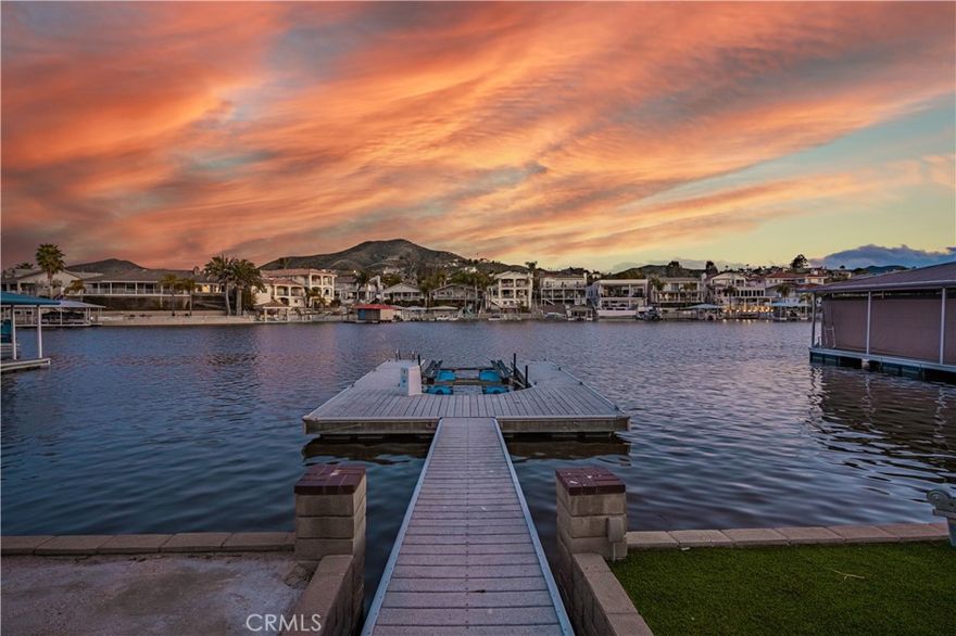 Waterfront "Paradise on East Bay Channel" in Canyon Lake.  Enjoy this stunning waterfront location and views!!! Perfectly situated on a prime lot with 70 ft of frontage.  You will experience breathtaking views of the mountains, boating, and wild life.  Newly remodeled kitchen boasts granite counter tops,  new cook top, dishwasher, newer wine fridge and a walk in pantry. Step thru the double door entry and take in the panoramic water views.  The spacious great room features vaulted ceilings, crown molding, and tile thru out.  A cozy wood burning fireplace in the family room with lots of natural sunlight coming thru the windows. Step outside to an expansive 800 sq ft deck with glass railing, seamlessly blending indoor and outdoor living. New ceiling fans on deck and in primary bedroom. The primary bedroom features shutters letting natural lite filter in along with a beautifully tiled walk in shower. A stylish vanity provides ample space and storage for daily use. This home is designed for both relaxation and entertainment featuring a private U-Dock with lift, allowing you to cruise the lake at a moments notice. Sea wall and terraced yard. The low maintenance yard ensures you have more time to enjoy the waterfront lifestyle. Additional upgrades include a new HVAC system, Professional Landscaping with Palm trees, and fresh paint. Whether you're hosting guests on your deck, enjoying lake views from your large windows, or out on the boat, this home delivers the ultimate lake experience. Flat driveway to park your boat or toys. Close to pickle ball courts, private lake for skiing and 18 hole SGA golf course.