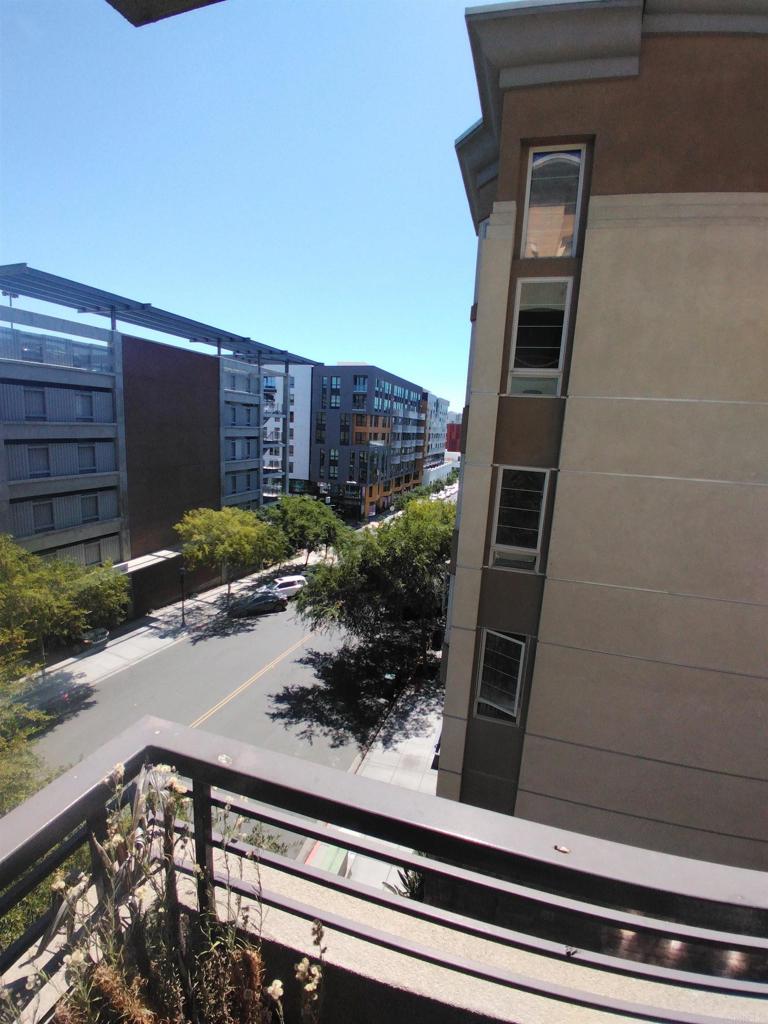 Bright corner unit with lots of windows provide light to this 744sqf condo. The living room offers ample room for relaxation and entertainment. There is 1 storage/coat closet, stackable washer and dryer, wood floors, full kitchen, private and elevated carpeted bedroom with spacious wardrobe closet and full-sized bathroom with tub shower. There is 1 dedicated parking space with a storage cage above. Building is beautifully kept and gated. Elevators, on-site gym, sauna, trash shoot on every floor, game room, lush outside landscape, and shared BBQs. Freeway entrance nearby along with, grocery stores, SD City College and dining.