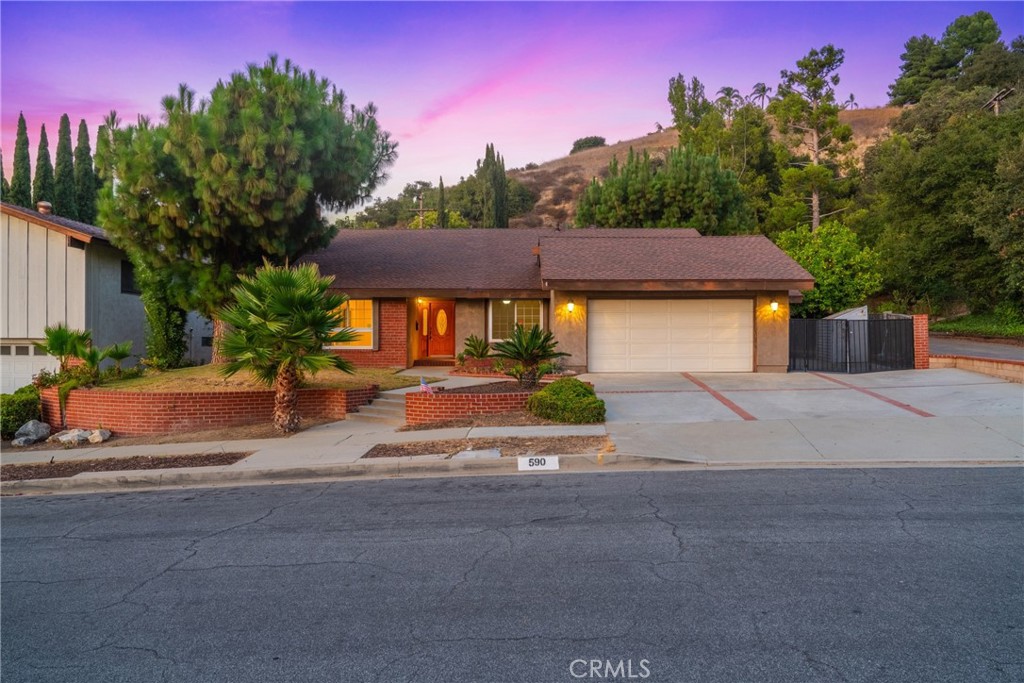 Beautiful single-story home located in a peaceful and desirable neighborhood, meticulously maintained with fresh interior paint throughout and a brand-new roof. Offering exceptional value in the area, this home is well priced and stands out for its spacious layout and quality upgrades. Step inside to discover a bright, modern kitchen featuring newly refinished white cabinets and elegant Quartz countertops. The main living area includes 3 spacious bedrooms and 3 full bathrooms, complemented by soaring ceilings in the entrance hallway and family room. Cozy living and formal dining rooms are enhanced with tasteful crown molding. The oversized master suite offers a private retreat for ultimate comfort. Dual pane windows contribute to energy efficiency. Additionally, this property features a rare and highly sought-after separate 2-bedroom, 1-bath, kitchenette unit with its own private entrance—perfect for multi-generational living or generating rental income. The wide-open backyard offers an inviting above-ground spa and built-in BBQ, ideal for outdoor entertaining and relaxation. This home’s unique four full-bath configuration is rarely found under $1 million in this neighborhood, making it an exceptional opportunity for buyers seeking both space and versatility. Conveniently located near the 60 and 57 freeways, colleges, shopping centers, and within walking distance to school.