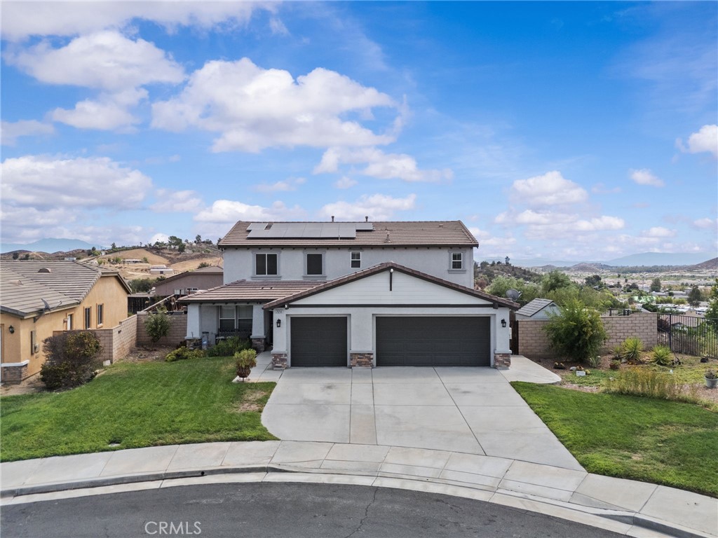 Welcome to this spacious and energy-efficient 4-bedroom, 3-bathroom home with a versatile bonus room that can easily be used or converted into a 5th bedroom. Located in the highly desirable Canyon Heights community of Menifee, this well-maintained property offers 2,648 Sq Ft of comfortable living space on a 10,019 Sq Ft flat lot—perfectly suited for a future pool, play area, or entertaining space. The backyard currently features a charming garden area with plenty of room to expand. Step inside to find a welcoming formal room that can be utilized in a variety of ways—home office, sitting room, or dining space. The upgraded wood-look laminate flooring and freshly painted walls flow throughout the entire first level, adding warmth and modern style. The open-concept family room seamlessly connects to the kitchen, featuring a custom built-in cabinet and a cozy fireplace with a unique custom tile backsplash, creating a stylish and functional gathering space. One full bedroom and bathroom located on the main level perfect for guests, in-laws, or a private office. Three additional bedrooms upstairs, including the primary suite with a large walk-in closet and private en-suite bathroom. Bonus room upstairs can easily be transformed into a 5th bedroom, playroom, office, etc. Two solar systems with a total of 31 solar panels for maximum energy savings with a whole house fan for efficient ventilation, New window screens with sun screens for added cooling and privacy, Nest smart thermostats for climate control, Bluetooth-enabled sprinkler controller, Tankless water heater for endless hot water, Ring doorbell with camera and keyless front door entry and outdoor security lights in the driveway and side of yard. Spacious backyard with a Covered patio with ceiling fans and recessed lighting perfect for outdoor gatherings and Stunning day and night views of the surrounding neighborhood and city. This home is located on a quiet cul-de-sac with just 7 homes safe and peaceful, ideal for children and families and also extremely low property taxes. Don’t miss out on this incredible opportunity to own a beautifully upgraded home in Canyon Heights—this one won’t last long!