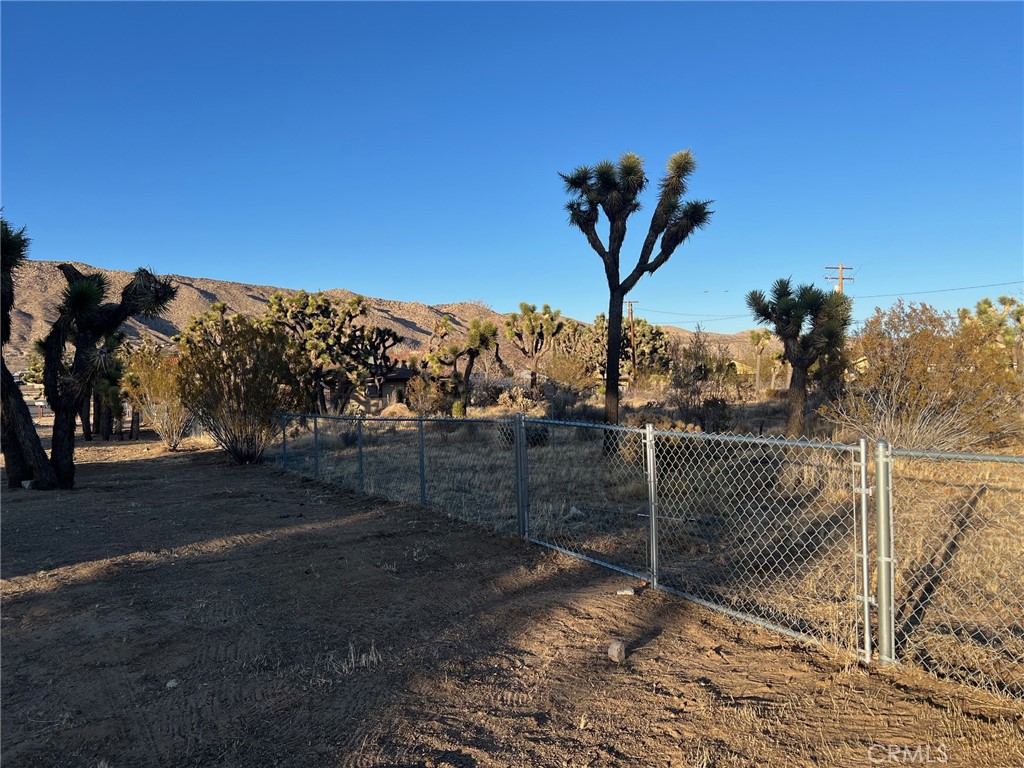 $10,000 PRICE REDUCTION!!!
Just over a Half Acre in town and Priced to Sell! Come take a look at this impressive parcel on Deer Trail, conveniently located just off Santa Fe in the Southwest area of Yucca Valley. This fully fenced property boasts excellent curb appeal on both sides of the street, making it an ideal investment opportunity. At 190' x 150' (0.65 acres), this lot gives a buyer the opportunity to build a good sized home and may accommodate a horse stable, how about using it as a Child Day Care facility. It also has great potential for installing manufactured homes, with utilities nearby and the sewer connection already in place. The property may also be split into two parcels with consultation and approval with the Town of Yucca Valley. The property is fully fenced, complete with a front gate, adding privacy and security to this prime piece of land. Don’t miss out on this fantastic opportunity – schedule a visit today! Price reduced from $45K to $35K