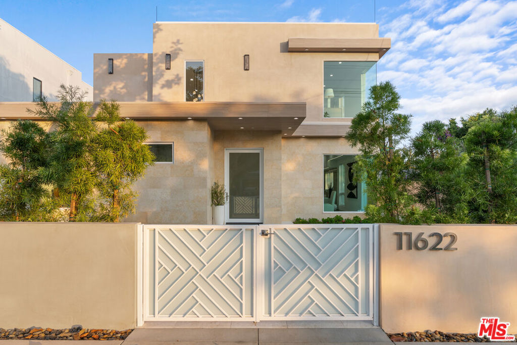 Experience the epitome of modern luxury living in this newly constructed smart home in the heart of Mar Vista. This stunning 4-bedroom, 4.5-bath residence boasts all en-suite bathrooms, plus an additional 1,500 sq ft of outdoor living space including a primary bedroom balcony and an expansive rooftop deck with breathtaking 360-degree views. Designed with an emphasis on light, space, and contemporary sophistication, the home features a dramatic glass-encased foyer staircase and an airy open-concept floor plan framed by expansive windows for abundant natural light. The chef's caliber kitchen impresses with custom cabinetry, striking quartzite countertops, a large entertaining island, and a full suite of Thermador appliances. Enjoy stylish comfort in the sun-filled family room with a sleek Dimplex LED fireplace set in marble design porcelain. The spacious primary suite offers dual walk-in closets and spa-like bath with large shower, soaking tub, and elevated designer finishes. Nothing has been spared, this residence is thoughtfully curated with high-end amenities including solar panels, pre-wiring for home stereo and electric shades, an EV charger, and smart systems as well as extensive safety features with eight exterior security cameras and an automatic driveway gate. Located moments from Mar Vista's beloved farmers market, trendy dining, and premier local shopping, this home blends uncompromising luxury with effortless convenience.