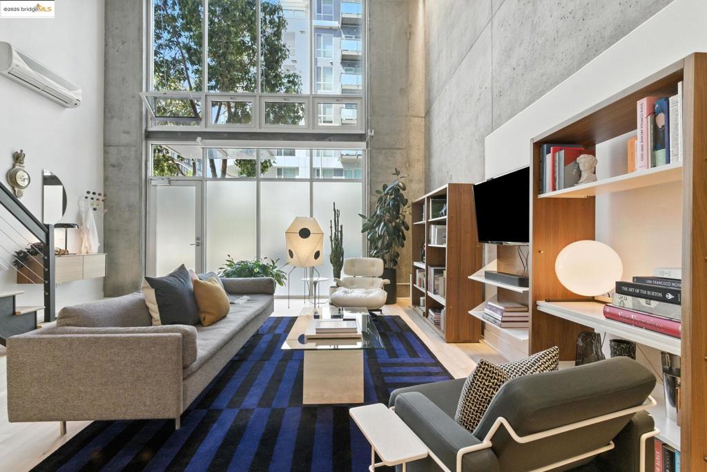 Sleek industrial vibes meet luxury finishes in this handsome live/work loft at The Sierra in Jack London Square. With soaring ceilings, floor-to-ceiling windows, and an open floorplan this home features an expansive first floor living and dining area with matte-finished maple floors and a well appointed kitchen w premium Dekton porcelain breakfast bar, wine fridge, and custom oak cabinetry—every detail curated. There are two ensuite bedrooms with spa-inspired bathrooms. The stylish 2nd story primary features a large walk-in closet with laundry. A mini split provides heat and AC, there’s a 7’ wide ceiling fan, warm LED lighting w dimmers, and a 20’ high wall of motorized blackout shades. Wired for high speed fiber. With a private street-level entrance this unit is super convenient for pet owners and versatile for those seeking a prime location for commercial pursuits. The Sierra offers full-service amenities: 24-hour lobby, package receiving, business center, lounge, rooftop decks views, gym, dry sauna, sun-soaked pool, secure parking, bike storage, and extra storage. Unbeatable location near restaurants, bars, shops, and amenities including Cellar Maker, Bicycle and Peerless Coffee, Nidos, Farmhouse Thai. 92 WalkScore®!—under ½ mile to Lake Merritt BART, near ferry/water taxi.