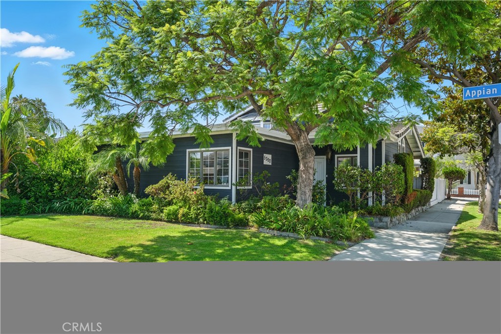 Lovely Belmont Park home featuring 3 bedrooms, 2 bathrooms, and 2,549 square feet of living space on an oversized 4,590 square foot corner lot. The tiled entryway welcomes you with vaulted ceilings accented by wood beams and a view of the downstairs living area. A step up leads to the formal living and dining rooms, where bamboo flooring and oversized windows add to the charm of the home - this area serves as an ideal setting for festive gatherings. The kitchen boasts granite countertops, white cabinetry, abundant storage, and two skylights along with a walk-through butler’s pantry that offers an additional refrigerator and even more storage for your essentials. The inviting family room is highlighted by a wood-accented ceiling with exposed beams and a striking stone fireplace. French doors open to the lushly landscaped backyard with slate stone, a pergola-covered patio, and seamless indoor-outdoor living. Downstairs, you’ll find two generously sized bedrooms with corner windows, ceiling fans, and built-in closets. A full bathroom with granite countertops, a shower/tub combo, and ample storage serves both bedrooms and guests. Additional hall storage and direct access to a two-car garage, plus a parking apron for one more car, complete this level. A floating, wood staircase leads to the light-filled second floor. The private, primary suite features new carpet, a spacious walk-in closet, and an ensuite bathroom with a makeup vanity, oversized shower with glass tile accents, and access to a large rooftop deck—perfect for morning coffee or sunset views. Located near Marine Stadium, 2nd Street shops and restaurants, Mother’s Beach, the Bay, 2nd & PCH, and award-winning schools, this home offers the best of Belmont Park living.
