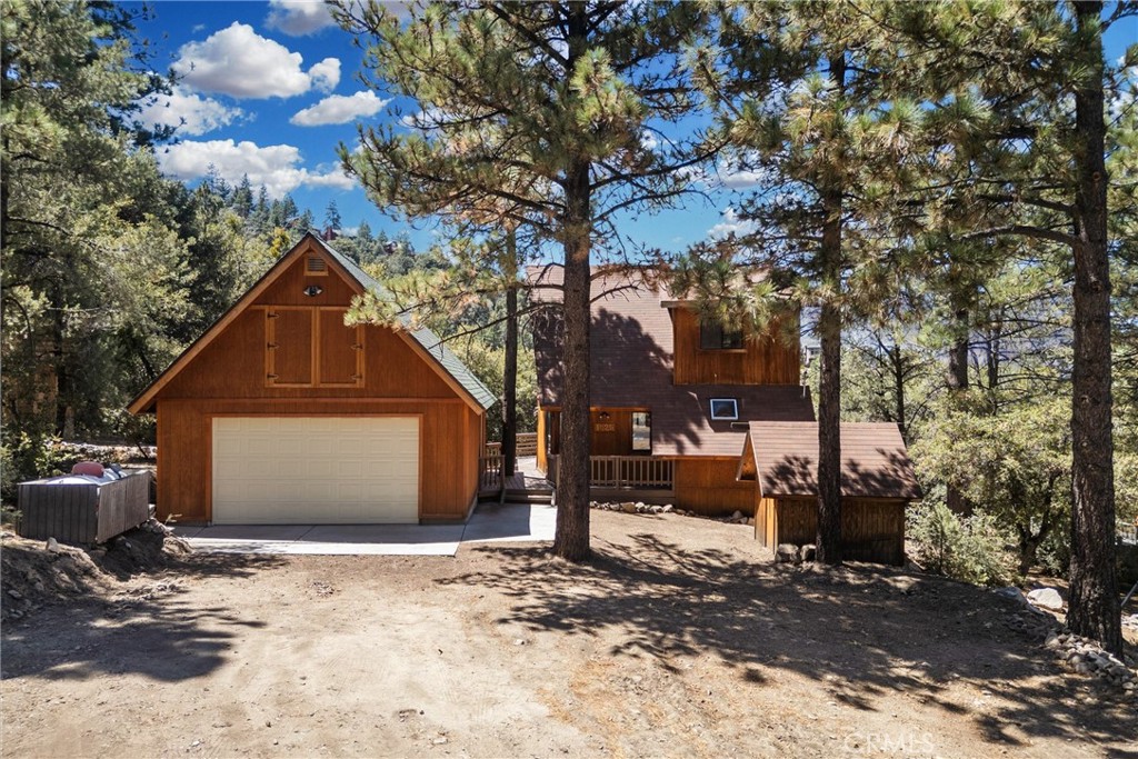 Tucked at the edge of Pine Mountain Club’s greenbelt, this cabin gives you a front-row seat to sweeping mountain views — no rooftops, just forest, sky, and the occasional deer wandering past. The decks were made for slow mornings with coffee, long summer dinners, and watching the seasons shift across the ridgeline.
Inside, vaulted ceilings and big windows keep the living space bright and airy. An open loft adds a versatile extra bedroom or retreat with a walk-in closet, while the main level offers a cozy living room with a wood-burning stove, a kitchen that flows into the family room, plus a comfortable bedroom and full bath.
Outside, a massive 20’x30’ garage with a second-story workshop means room for cars, ATVs, tools — and all your big ideas. The flat, street-level lot makes access easy in every season.
Whether you’re looking for a weekend hideaway or a full-time mountain home, 1625 Woodland Drive offers that rare mix of privacy, views, and practicality — all in one inviting cabin.
Ownership in Pine Mountain Club includes membership in the Property Owners Association, with dues of $165 per month. This provides access to a variety of amenities: an Olympic-style pool and spa, tennis and pickleball courts, a nine-hole scenic golf course, an equestrian center, and more. The community also offers essential year-round services like 24/7 patrol, trash and recycling pickup, road maintenance, and snow removal. For added peace of mind, Kern County Fire Station 58—equipped with paramedics and a helipad—is located right in the community to ensure fast emergency response when needed.