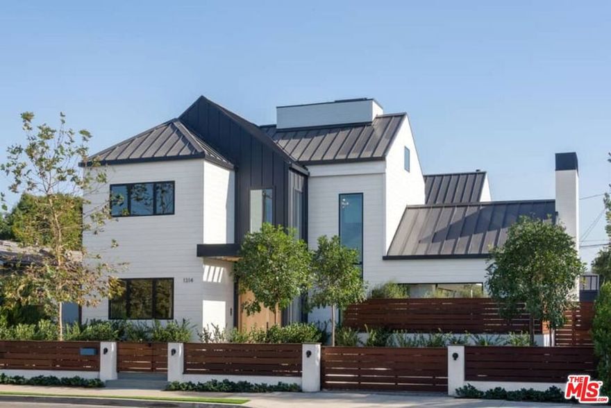 Spectacular, inspired Modern Farmhouse from GreveBuilt and Hamilton Architects. Exceptional light-filled home for entertaining with dramatic soaring two-story foyer and expansive living, dining, and great rooms, all seamlessly framed by artful walls of sliding glass. Masterwork kitchen with full Viking suite. Master suite aerie with gracious volume and dramatic beamed ceiling. Three-story glass-framed architectural jewel-box master staircase. Fully-equipped 4K home theater/media room. Wine room. Billiard's room. Basement white brick-style wall magically rolls away to reveal gym/pilates studio or top-secret workspace for the latest transformative start-up. Additional multiple office opportunities for at-home productivity. Smart Home with installed Ipads. Sparkling swimmers pool and spa. Separate guesthouse/office with outdoor shower. Ample backyard for pets or play on a rare, nearly 11,000 square foot flat lot. BBQ bar and spacious decking for entertaining under the sun and stars. Solar panels. A singular, Ultimate Staycation resort-inspired Venice home, blending glamorous indoor/outdoor living, comfort and unparalleled amenities.