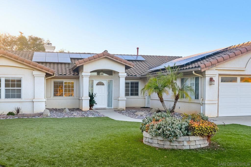 Welcome to your private escape in the hills of North Escondido, bordering Valley Center. This spacious 5-bedroom, 3-bathroom home spans 2,462 sq. ft. and sits proudly on 2 fully fenced acres, offering the perfect balance of privacy, comfort, and modern living. From the moment you arrive, you’ll be greeted by sweeping views, a long private driveway, and the charm of a single-story layout designed for effortless living. The exterior showcases low maintenance landscaping and an inviting front entry framed by palm trees. Inside, the open-concept kitchen shines with granite countertops, stainless steel appliances, and abundant cabinetry, making it the heart of the home. Natural light flows through every room, highlighting fresh finishes and spacious living areas. With five full bedrooms, there’s room for everyone whether you’re accommodating a growing family, creating a home office, or setting up a guest retreat. The primary suite is a true sanctuary, featuring a spa-like bathroom with dual vanities, a soaking tub, and a walk-in closet. Additional bedrooms and bathrooms are equally inviting, with updated flooring and bright, modern touches throughout. Step outside to discover wide-open spaces perfect for entertaining, gardening, or even keeping animals. The covered patio and gazebo provide the ideal backdrop for al fresco dining or relaxing evenings under the stars. Plus, with solar panels, you’ll enjoy energy efficiency and peace of mind.