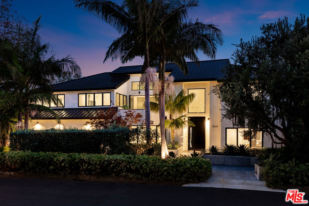 In the coveted, prestigious Palisades Riviera rests a pristine resort-inspired coastal architectural, surrounded by lush landscaping on oasis-like grounds that offer a blend of soothing natural elements and serene outdoor leisure spaces. Inside, natural light fills the double-height foyer that opens to the public entertaining areas. A commanding floor-to-ceiling fireplace partitions the family room and formal living room, each fitted with walls of sliding glass that frame vivid greenery. Nearby, the formal dining room is perfect for intimate gatherings and celebrations. The sleek, modern kitchen is appointed with custom imported cabinetry, Miele appliances, center island with prep sink, and breakfast bar. On the second level, positioned central to the bedrooms, is a private patio with treetop views adjacent to the pajama room. The oversized primary suite has lofty ceilings, custom built-ins, a makeup station, walk-in closet with shelving. A balcony connects the main bedroom to the lavish bath equipped with a floating wraparound vanity, separate soaking tub, and large rainwater shower. In the backyard, enjoy an abundance of amenities such as a sprawling lounging deck with brand-new retractable awning, overhead heaters, and outdoor kitchen with commercial-grade pizza oven, barbecue, and bar ledge. There is plenty of grassy space to play, a sparkling pool, spa with water feature, and a spacious pool house/cabana with flat screen, poolside shower, and bathroom. A wall of privacy hedges and tropical plantings provides utmost seclusion and peace. The serene waterfall fills a tranquil pond, replete with blossoming lily pads, that encircles the fire pit for casual evenings under California skies. Located on D'Este Drive, one of the most highly desired, non-through streets with a park-like feel, this home is just moments to the Riviera Country Club, tennis club, hiking trails, and all that makes life here so pleasant. Enjoy close proximity to award-winning schools, top-rated restaurants, boutiques, beaches, and the best of the Westside. Welcome!