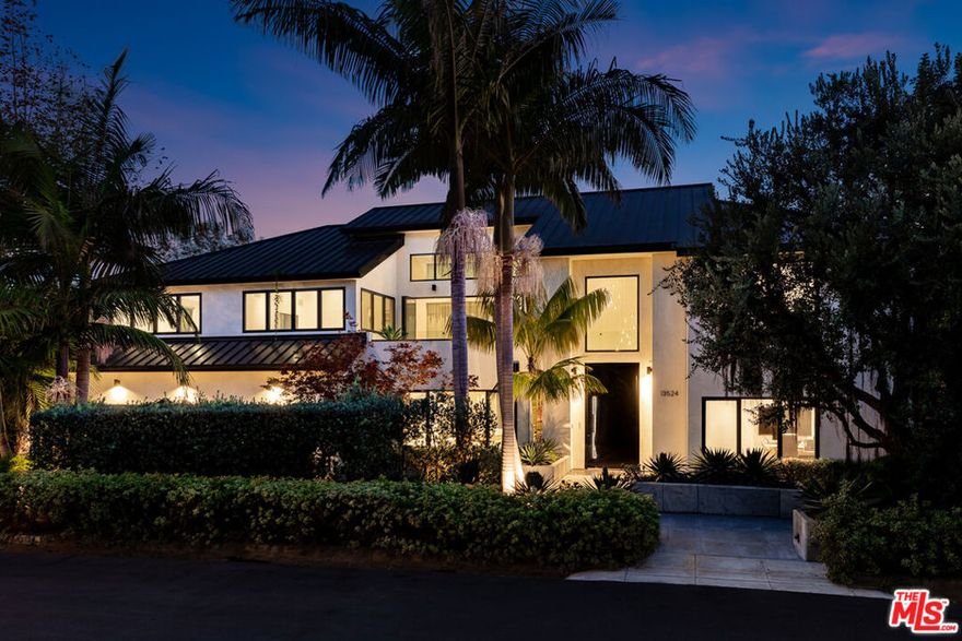 In the coveted, prestigious Palisades Riviera rests a pristine resort-inspired coastal architectural, surrounded by lush landscaping on oasis-like grounds that offer a blend of soothing natural elements and serene outdoor leisure spaces. Inside, natural light fills the double-height foyer that opens to the public entertaining areas. A commanding floor-to-ceiling fireplace partitions the family room and formal living room, each fitted with walls of sliding glass that frame vivid greenery. Nearby, the formal dining room is perfect for intimate gatherings and celebrations. The sleek, modern kitchen is appointed with custom imported cabinetry, Miele appliances, center island with prep sink, and breakfast bar. On the second level, positioned central to the bedrooms, is a private patio with treetop views adjacent to the pajama room. The oversized primary suite has lofty ceilings, custom built-ins, a makeup station, walk-in closet with shelving. A balcony connects the main bedroom to the lavish bath equipped with a floating wraparound vanity, separate soaking tub, and large rainwater shower. In the backyard, enjoy an abundance of amenities such as a sprawling lounging deck with brand-new retractable awning, overhead heaters, and outdoor kitchen with commercial-grade pizza oven, barbecue, and bar ledge. There is plenty of grassy space to play, a sparkling pool, spa with water feature, and a spacious pool house/cabana with flat screen, poolside shower, and bathroom. A wall of privacy hedges and tropical plantings provides utmost seclusion and peace. The serene waterfall fills a tranquil pond, replete with blossoming lily pads, that encircles the fire pit for casual evenings under California skies. Located on D'Este Drive, one of the most highly desired, non-through streets with a park-like feel, this home is just moments to the Riviera Country Club, tennis club, hiking trails, and all that makes life here so pleasant. Enjoy close proximity to award-winning schools, top-rated restaurants, boutiques, beaches, and the best of the Westside. Welcome!