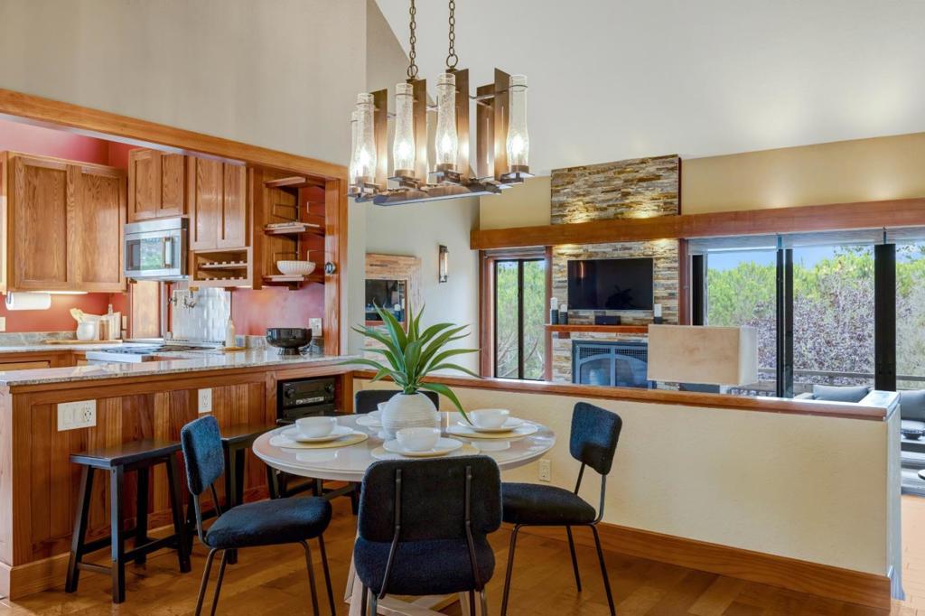 Discover the essence of Carmel charm in this beautifully updated two-bedroom, two-bath townhome with a dedicated office, perfectly perched just moments from downtown Carmel, Pebble Beach, and Monterey Peninsula Hospital. Blending timeless seaside character with modern sophistication, this serene end-unit retreat offers both luxury and privacy in an unbeatable location. Step inside to find a thoughtfully designed interior featuring rich hardwood floors, custom lighting, and an elegant palette. The main level showcases a spacious primary suite, a light-filled kitchen with custom cabinets, mountain views, and a dramatic living room with vaulted ceilings, an inviting fireplace, and a deck ideal for enjoying breathtaking sunrises and sunsets. Downstairs, a second bedroom, full bath, laundry room, and a flexible office or study open onto a tranquil walkout patio, your own private escape for morning coffee or evening wine. Nearly every window frames peaceful, mountain views, creating a constant connection to nature. Additional highlights include a detached two-car garage and a workshop and storage area, rare amenities in this coveted location. This is coastal California living at its finest. Sophisticated, quiet, and effortlessly close to everything that makes Carmel extraordinary.